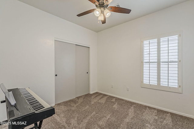 unfurnished bedroom featuring carpet flooring, a closet, and ceiling fan