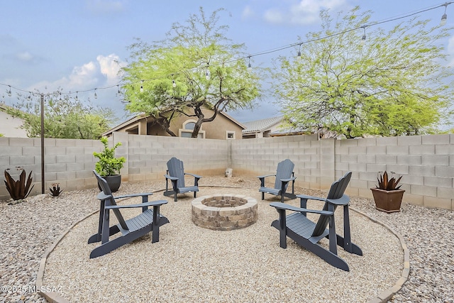 view of patio / terrace featuring a fire pit and a fenced backyard