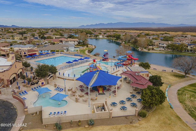 aerial view of a water and mountain view and a pool area