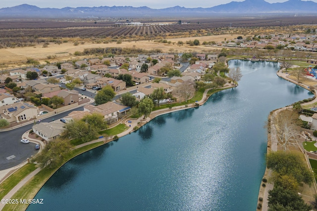 aerial view of property and surrounding area with a water and mountain view and nearby suburban area