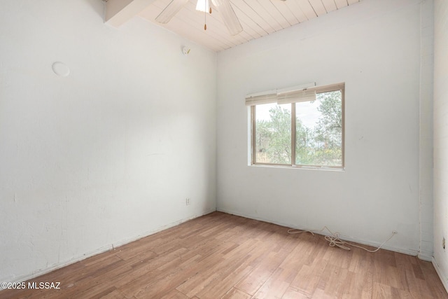 spare room featuring beam ceiling, a ceiling fan, and light wood-style floors