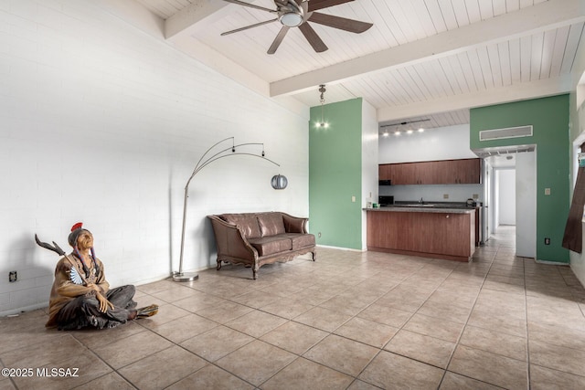 unfurnished room with ceiling fan, wooden ceiling, beam ceiling, light tile patterned floors, and high vaulted ceiling