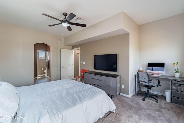 4296 N Rillito Creek Pl, Tucson, AZ 85719 - bedroom with arched walkways, carpet, ceiling fan, a desk, and baseboards