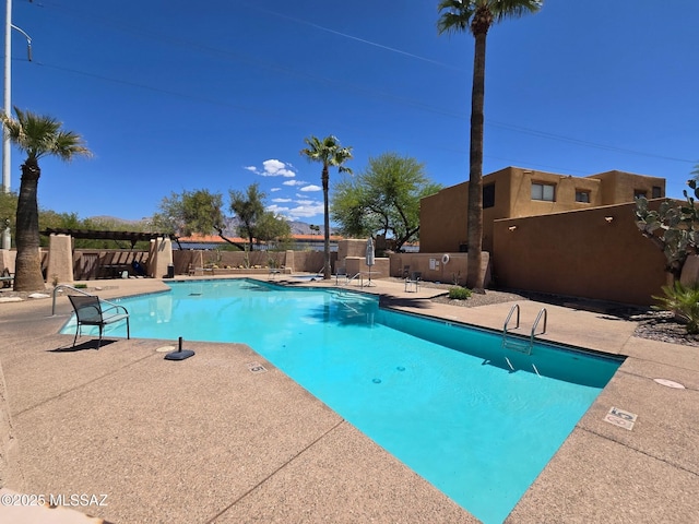 4296 N Rillito Creek Pl, Tucson, AZ 85719 - community pool with a patio and fence
