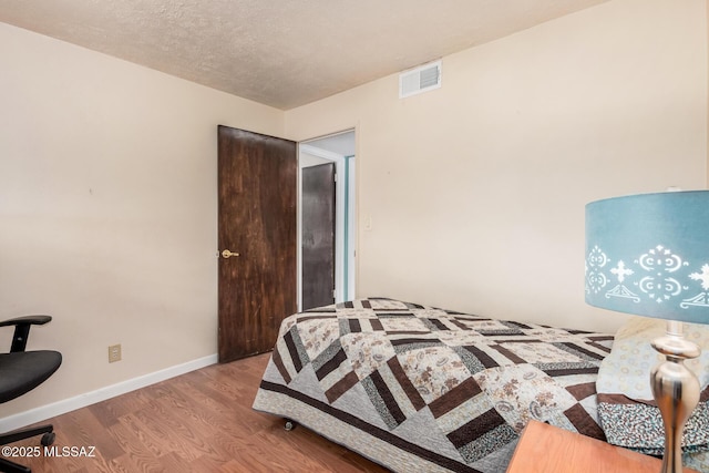 8360 E Mary Dr, Tucson, AZ 85730 - bedroom with wood finished floors and baseboards