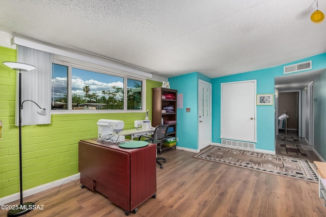 8360 E Mary Dr, Tucson, AZ 85730 - office with a textured ceiling, wood finished floors, and baseboards