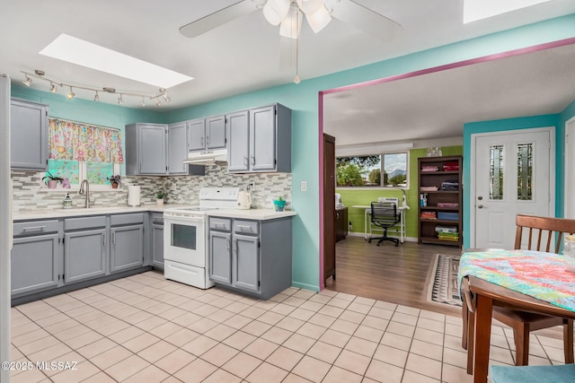 8360 E Mary Dr, Tucson, AZ 85730 - kitchen featuring white electric stove, gray cabinets, under cabinet range hood, light countertops, and tasteful backsplash