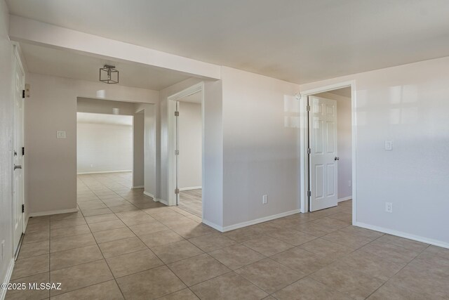 6664 E Mary Dr, Tucson, AZ 85730 - empty room with light tile patterned floors and baseboards