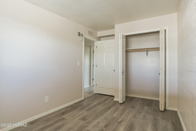 6664 E Mary Dr, Tucson, AZ 85730 - unfurnished bedroom featuring wood finished floors, baseboards, and a closet