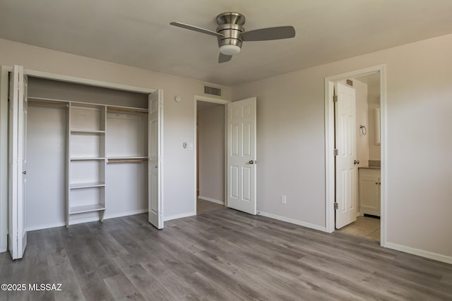 6664 E Mary Dr, Tucson, AZ 85730 - unfurnished bedroom with wood finished floors, a closet, and baseboards