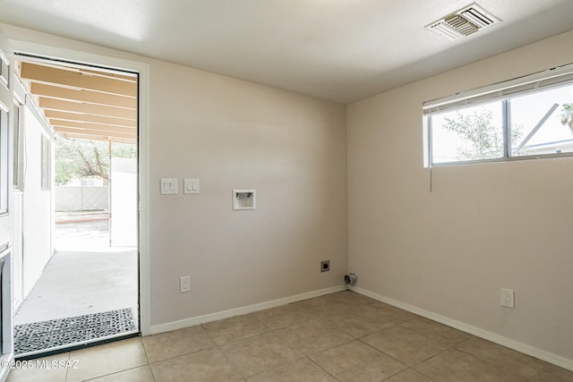 6664 E Mary Dr, Tucson, AZ 85730 - laundry area with hookup for a washing machine, electric dryer hookup, light tile patterned floors, and baseboards