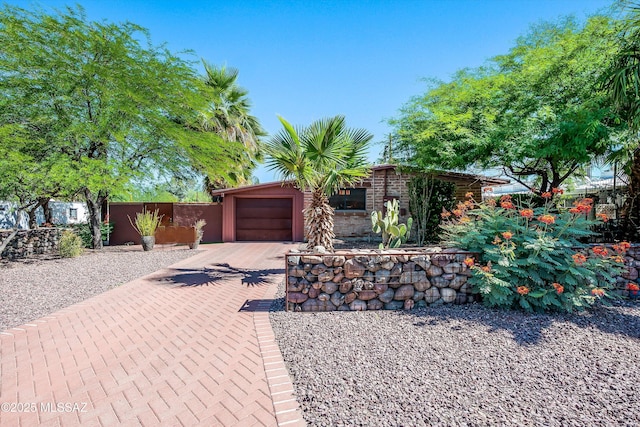 4631 E Bellevue St, Tucson, AZ 85712 - view of front facade featuring concrete driveway, a garage, and fence