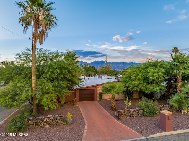 4631 E Bellevue St, Tucson, AZ 85712 - view of front of property with a mountain view, an attached garage, and driveway