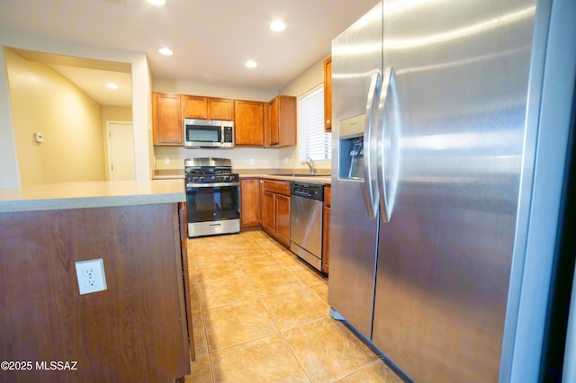 14333 S Camino Vallado, Sahuarita, AZ 85629 - kitchen featuring appliances with stainless steel finishes, a sink, light countertops, recessed lighting, and light tile patterned floors