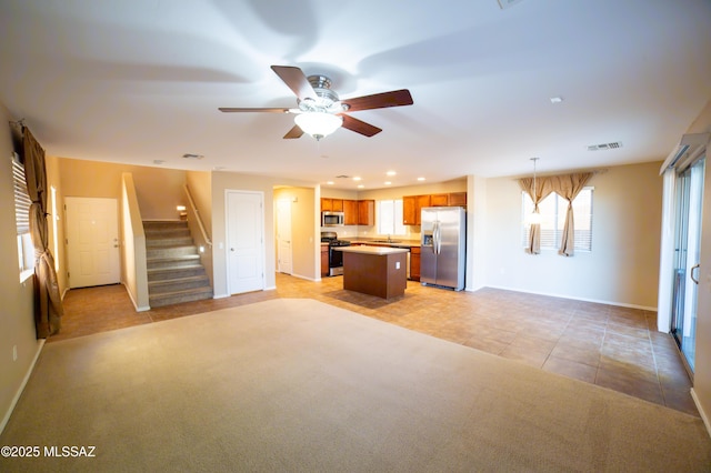 14333 S Camino Vallado, Sahuarita, AZ 85629 - unfurnished living room featuring ceiling fan, stairs, healthy amount of natural light, light tile patterned flooring, and recessed lighting
