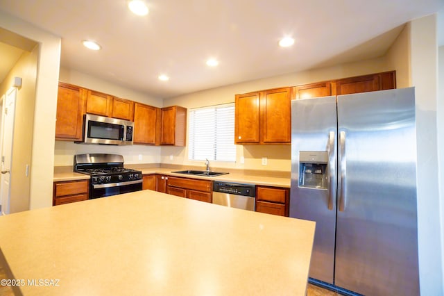 14333 S Camino Vallado, Sahuarita, AZ 85629 - kitchen featuring stainless steel appliances, a sink, brown cabinets, light countertops, and recessed lighting