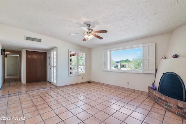 2831 W Puccini Pl, Tucson, AZ 85741 - unfurnished living room featuring a ceiling fan, light tile patterned floors, and a textured ceiling