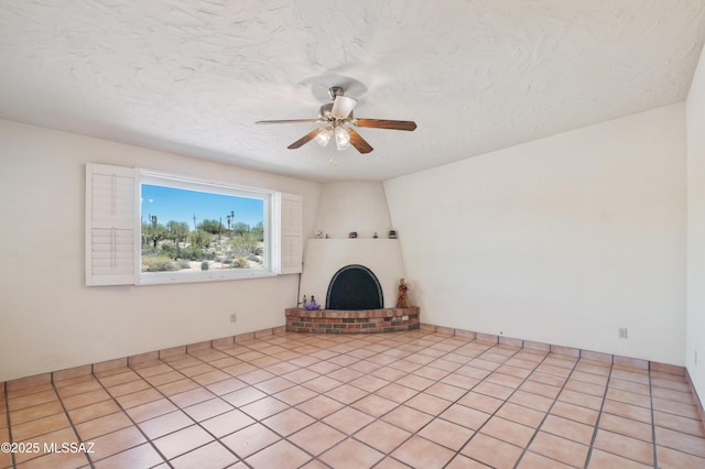 2831 W Puccini Pl, Tucson, AZ 85741 - unfurnished living room with a fireplace, ceiling fan, and a textured ceiling