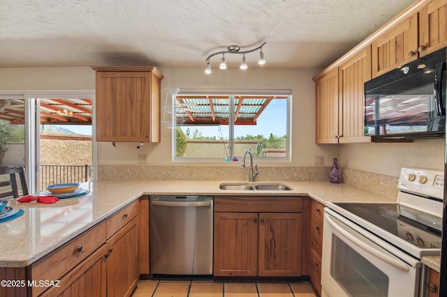 2831 W Puccini Pl, Tucson, AZ 85741 - kitchen featuring white range with electric stovetop, black microwave, dishwasher, a sink, and light tile patterned floors