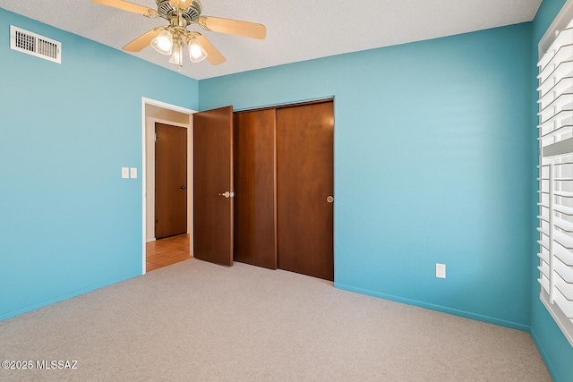 2831 W Puccini Pl, Tucson, AZ 85741 - unfurnished bedroom featuring light carpet, a closet, and a ceiling fan