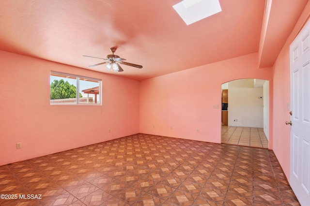 2831 W Puccini Pl, Tucson, AZ 85741 - empty room featuring arched walkways, ceiling fan, and a skylight