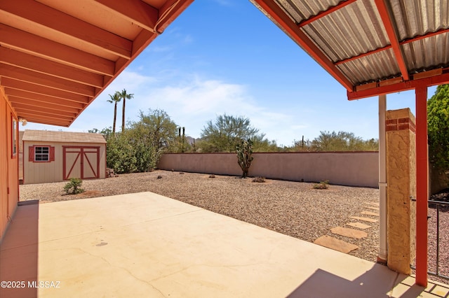 2831 W Puccini Pl, Tucson, AZ 85741 - view of patio featuring a storage unit, an outbuilding, and a fenced backyard