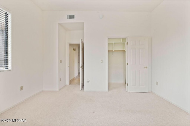 11126 N Guava Dr, Oro Valley, AZ 85737 - unfurnished bedroom with carpet, a spacious closet, baseboards, and a closet