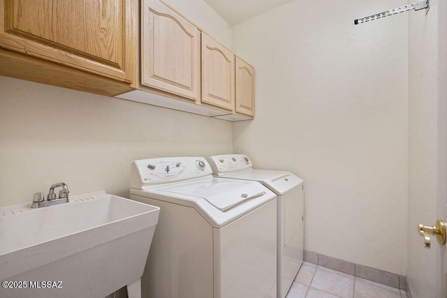 11126 N Guava Dr, Oro Valley, AZ 85737 - clothes washing area featuring washer and clothes dryer, cabinet space, light tile patterned flooring, and baseboards