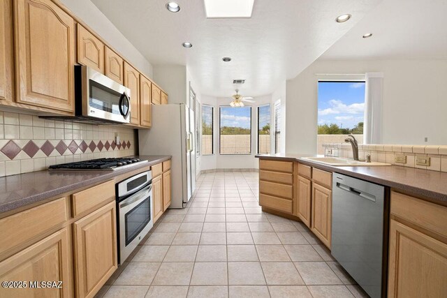 11126 N Guava Dr, Oro Valley, AZ 85737 - kitchen featuring appliances with stainless steel finishes, a sink, light brown cabinetry, decorative backsplash, and recessed lighting