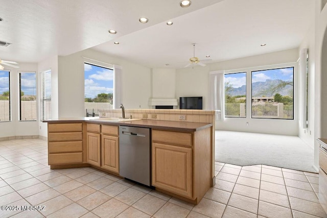 11126 N Guava Dr, Oro Valley, AZ 85737 - kitchen with stainless steel dishwasher, open floor plan, a sink, ceiling fan, and light tile patterned flooring
