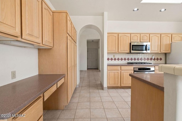 11126 N Guava Dr, Oro Valley, AZ 85737 - kitchen with light brown cabinets, stainless steel microwave, gas cooktop, freestanding refrigerator, and light tile patterned flooring