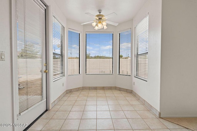 11126 N Guava Dr, Oro Valley, AZ 85737 - unfurnished sunroom with plenty of natural light, baseboards, and tile patterned floors