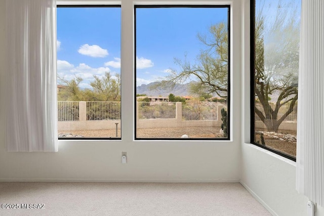 11126 N Guava Dr, Oro Valley, AZ 85737 - unfurnished room with carpet floors, a mountain view, plenty of natural light, and baseboards