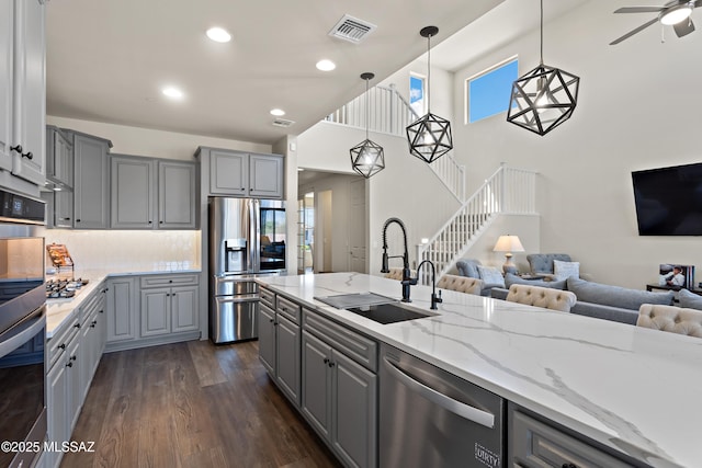7809 S Land Grant Dr, Tucson, AZ 85747 - kitchen with gray cabinets, stainless steel appliances, a sink, open floor plan, and recessed lighting