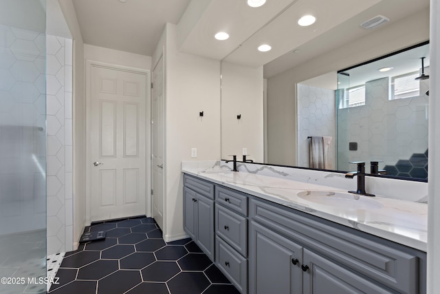 7809 S Land Grant Dr, Tucson, AZ 85747 - bathroom featuring tiled shower, double vanity, tile patterned floors, and recessed lighting