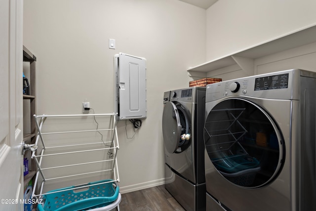 7809 S Land Grant Dr, Tucson, AZ 85747 - laundry room featuring dark wood-style floors, washing machine and clothes dryer, baseboards, and electric panel