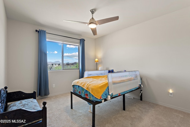 7809 S Land Grant Dr, Tucson, AZ 85747 - carpeted bedroom featuring baseboards and a ceiling fan