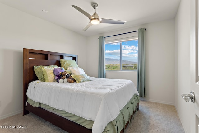 7809 S Land Grant Dr, Tucson, AZ 85747 - bedroom featuring light colored carpet, a ceiling fan, and baseboards