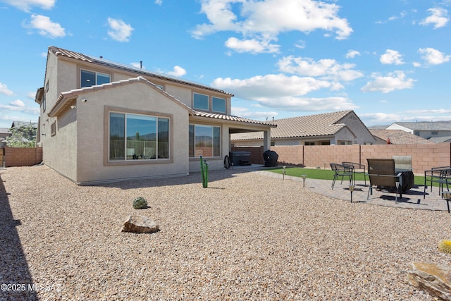 7809 S Land Grant Dr, Tucson, AZ 85747 - rear view of property with stucco siding, a patio, and a fenced backyard