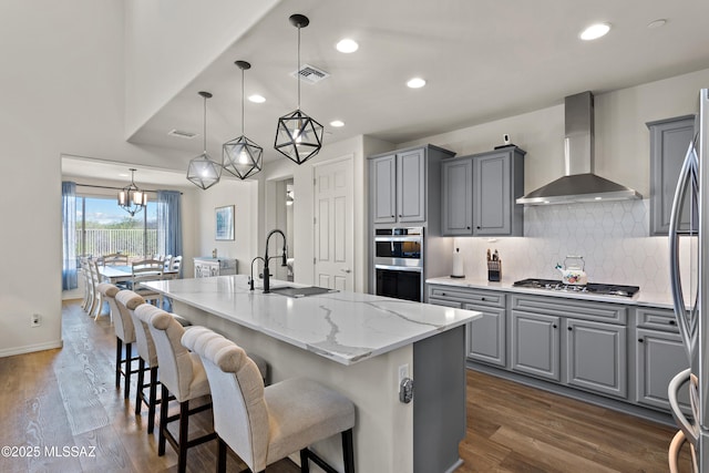 7809 S Land Grant Dr, Tucson, AZ 85747 - kitchen featuring gray cabinets, wall chimney range hood, a sink, stainless steel appliances, and recessed lighting
