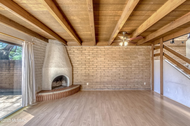 2777 N Treat Ave, Tucson, AZ 85716 - unfurnished living room featuring wood ceiling, wood finished floors, a ceiling fan, brick wall, and beam ceiling