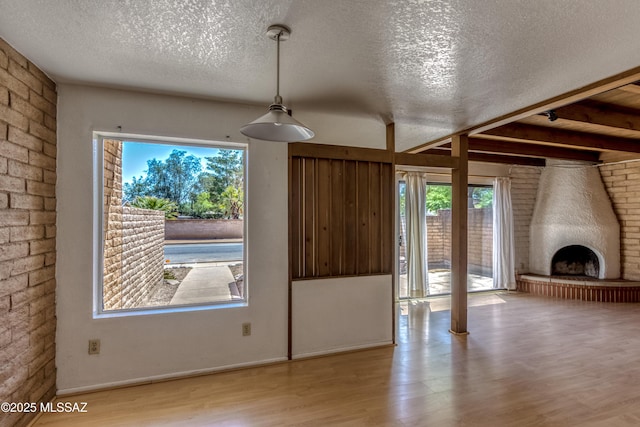 2777 N Treat Ave, Tucson, AZ 85716 - unfurnished living room with a textured ceiling, wood finished floors, and plenty of natural light