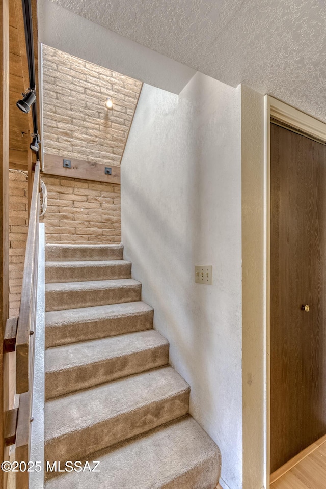 2777 N Treat Ave, Tucson, AZ 85716 - staircase with a textured ceiling and lofted ceiling