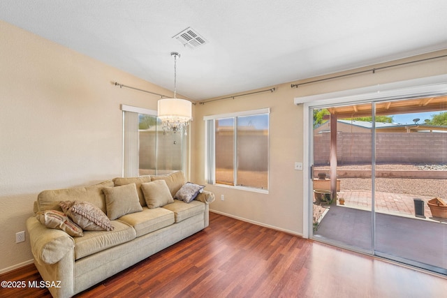 8892 E Apache Well Pl, Tucson, AZ 85730 - living room with wood finished floors, a chandelier, and baseboards