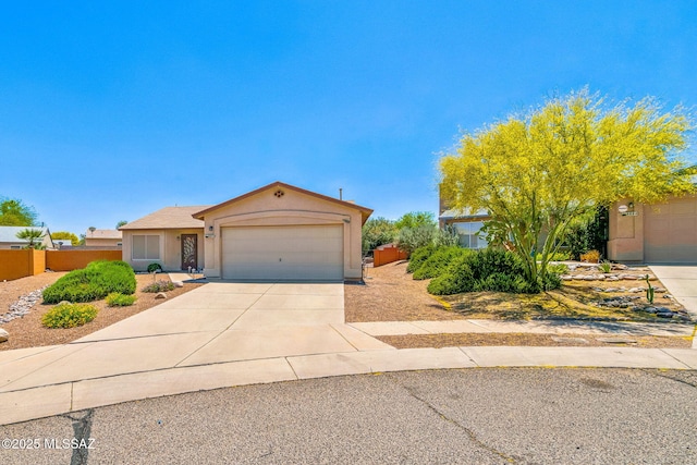 8892 E Apache Well Pl, Tucson, AZ 85730 - view of front facade featuring a garage, concrete driveway, stucco siding, and fence