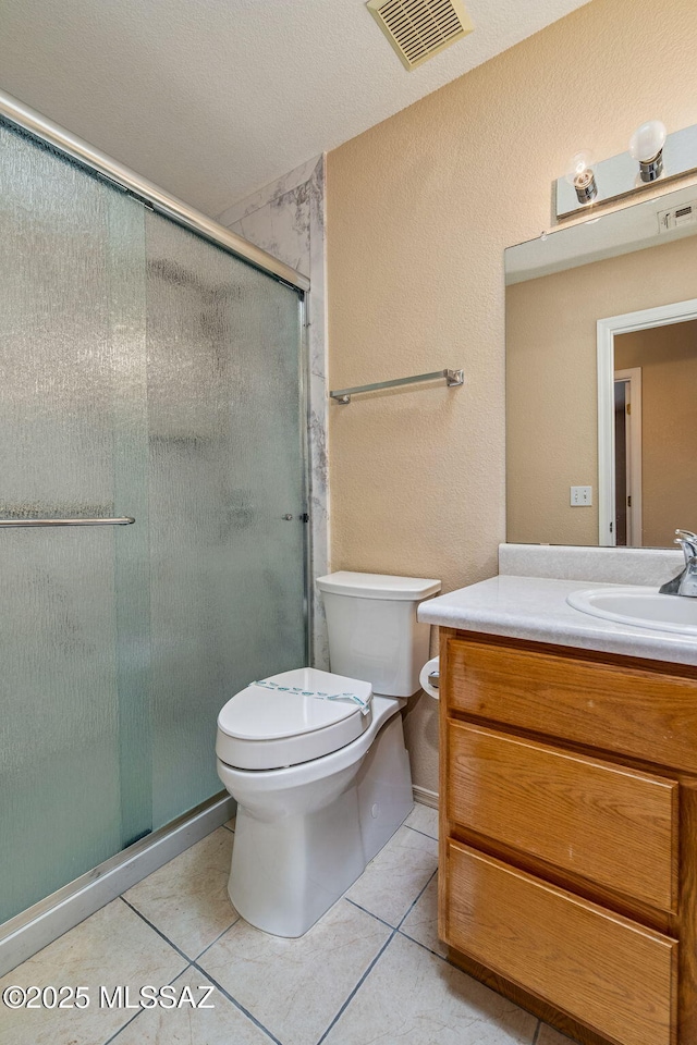 8892 E Apache Well Pl, Tucson, AZ 85730 - full bathroom featuring toilet, a stall shower, vanity, and tile patterned flooring