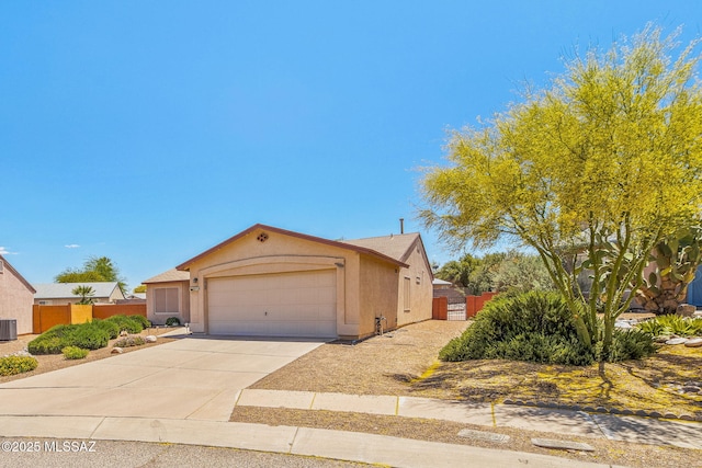 8892 E Apache Well Pl, Tucson, AZ 85730 - view of front of home featuring an attached garage, stucco siding, central AC, driveway, and fence