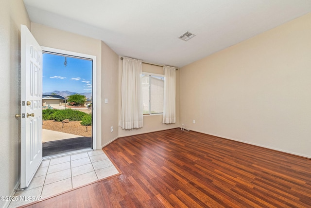8892 E Apache Well Pl, Tucson, AZ 85730 - empty room with wood finished floors, healthy amount of natural light, and baseboards