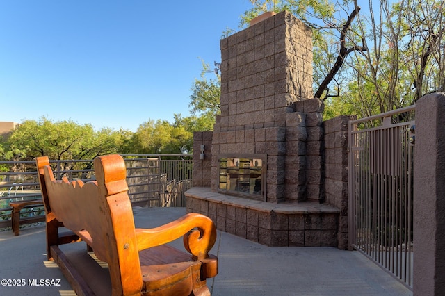 view of patio / terrace with a multi sided fireplace