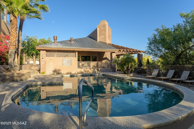 view of pool featuring a patio area and fence